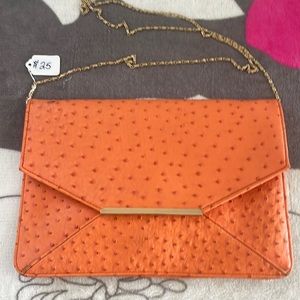 Pretty orange flat purse with gold chain
